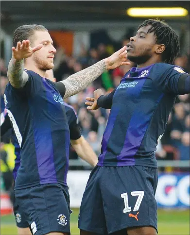  ??  ?? ARMS DEAL: Luton’s Pelly-Ruddock Mpanzu celebrates his goal with George Moncur