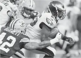  ?? GREGORY SHAMUS/GETTY IMAGES ?? LeSean McCoy of the Philadelph­ia Eagles battles for yards last Sunday against the Green Bay Packers. He leads the NFL in rushing after Week 10 with 932 yards.