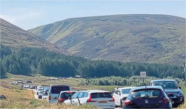  ??  ?? HEAD FOR THE HILLS: The jammed Loch Muick car park on July 31 was one of the areas that had problems with antisocial campers as people sought a change of scene