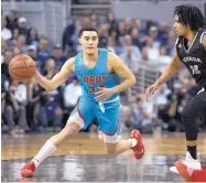  ?? TOM R. SMEDES/ASSOCIATED PRESS ?? New Mexico guard Drue Drinnon passes around Nevada guard Jazz Johnson during Saturday afternoon’s game in Reno against the sixth-ranked Wolf Pack.