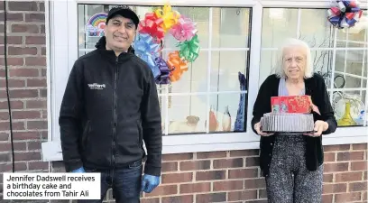  ??  ?? Jennifer Dadswell receives a birthday cake and chocolates from Tahir Ali