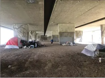  ?? PHOTOS BY NATALIE HANSON — ENTERPRISE-RECORD ?? Campers on Thursday and Friday slowly began to leave the area under the Highway 99 overpass in Bidwell Park in Chico as notices from Chico police officers gave different deadlines to leave the area.