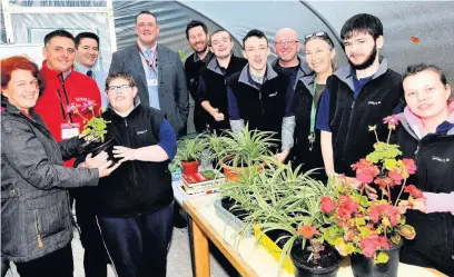  ??  ?? Students at Heronsbrid­ge School in their new polytunnel donated by Lovell and Hafod