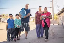  ?? ROBERTO E. ROSALES/JOURNAL ?? Emma Palacios, far right, worries about getting drinking water for her family in Anapra, a working class neighborho­od of Ciudad Juárez near the border.