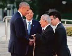  ?? AP ?? US President Barack Obama with Sunao Tsuboi (second right), a survivor of the 1945 atomic bombing, and Japanese Prime Minister Shinzo Abe, yesterday.