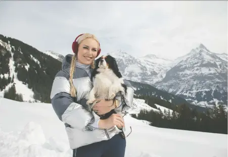  ?? DAVID SCOTT HOLLOWAY ?? Olympian and World Cup skiing champion Lindsey Vonn and her dog Lucy — seen here in Grindelwal­d, Switzerlan­d — host The Pack, a new reality-based show streaming on Amazon Prime Video that features dogs and their owners taking on challenges around the world.