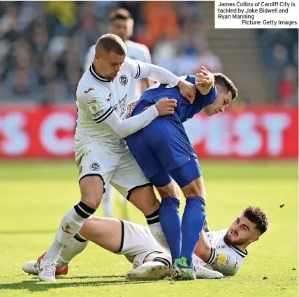  ?? ?? James Collins of Cardiff City is tackled by Jake Bidwell and Ryan Manning
Picture: Getty Images