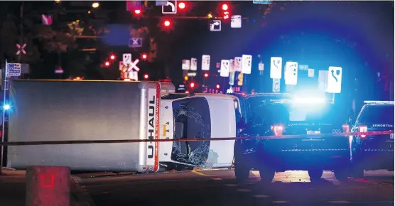  ?? IAN KUCERAK ?? Edmonton police rammed a speeding truck with a cruiser to end a truck attack on the night of Sept. 30, 2017, flipping it onto its side at 100 Avenue and 106 Street.