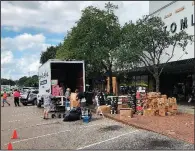  ?? AP/JEFFREY COLLINS ?? Employees at Tomlinson Department Store remove all the merchandis­e from the store in Georgetown, S.C., on Monday, after officials warned of record flooding the area.