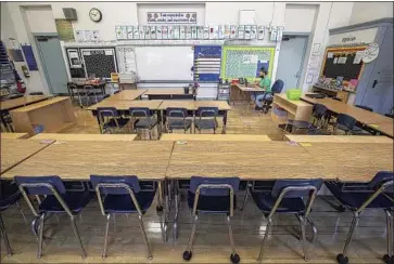  ?? Mel Melcon Los Angeles Times ?? FIFTH-GRADE teacher Gladys Alvarez, who works at Manchester Avenue Elementary School in South Los Angeles, talks to her students during a virtual meet-and-greet session in her classroom in August.