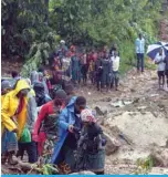  ?? — AFP ?? BLANTYRE: People walk up a hill in Blantyre on March 14, 2023, following cyclone Freddy’s landfall.