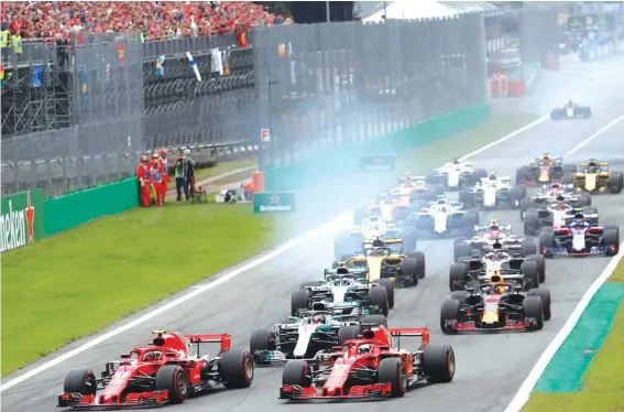  ??  ?? Kimi Raikkonen and Sebastian Vettel lead the pack at the start of yesterday’s Italian GP Photo: AP