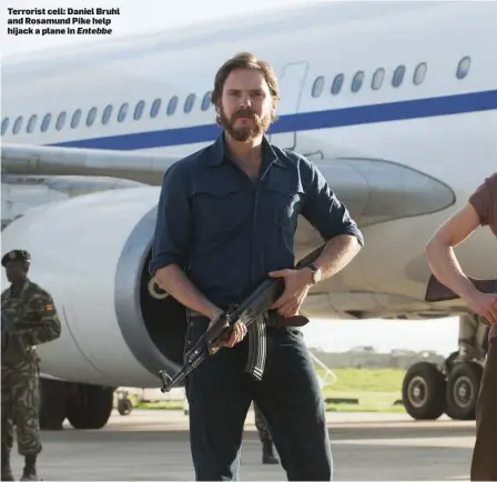  ??  ?? Terrorist cell: Daniel Bruhl and Rosamund Pike help hijack a plane in Entebbe