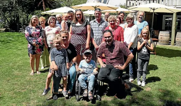  ?? JANE MATTHEWS/FAIRFAX NZ ?? Behind the to-be-wed couple, Erin Feasey, Myles Webb and their children, stand few of the many ‘helping’ members of the community.