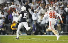  ?? Justin K. Aller / Getty Images ?? Penn State’s Grant Haley returns a blocked field goal for the winning TD.