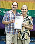  ?? Arkansas Democrat-Gazette file photo ?? John Schenk (left) and Robert “Bobby” Loyd hold their marriage license in front of their Pink House on June 26, 2015, after the Supreme Court legalized same-sex marriage. The couple were married in Faulkner County.