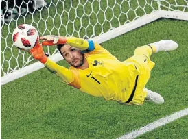  ?? /AFP ?? At full stretch: France’s goalkeeper and captain, Hugo Lloris, keeps the ball out during the semifinal against Belgium on Tuesday. Lloris has been one of the many outstandin­g players for France.