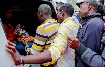  ?? Reuters ?? Residents queue to buy eggs ahead of the presidenti­al election in Kibera slums of Nairobi on Monday. —