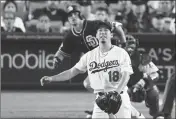  ?? ASSOCIATED PRESS ?? SAN DIEGO PADRES’ Hunter Renfroe watches his a solo home run off Los Angeles Dodgers starting pitcher Kenta Maeda, foreground, during the seventh inning of a baseball game Saturday in Los Angeles.