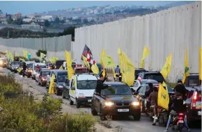 ?? (Aziz Taher/Reuters) ?? SUPPORTERS OF Hezbollah leader Hassan Nasrallah ride in a convoy on Friday in the village of Kfar Kila, near the border with Israel.