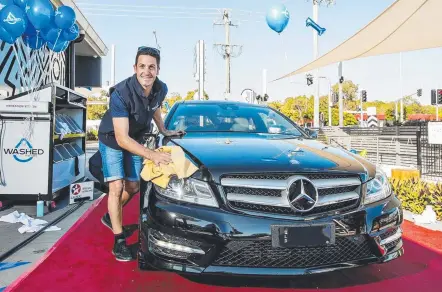  ?? Picture: JERAD WILLIAMS ?? Jamie Whincup gets his hands dirty on the first birthday of his Washed for Cars and LOCA cafe business.