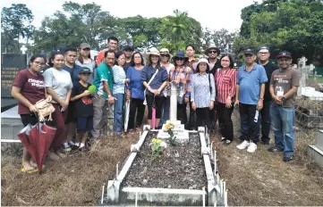  ??  ?? The Clan members at one of the graves.