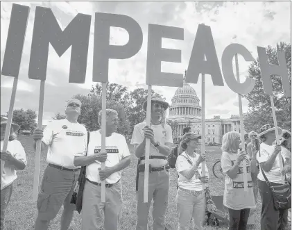  ?? J. SCOTT APPLEWHITE/AP ?? Activists rally Thursday for the impeachmen­t of President Donald Trump at the Capitol in Washington. Speaker of the House Nancy Pelosi, D-Calif., committed Tuesday to launching a formal impeachmen­t inquiry against Trump.