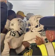  ?? ASSOCIATED PRESS FILE PHOTO ?? Security and police break up a scuffle between Michigan and Michigan State players at Michigan Stadium last month. The Big Ten has fined MSU $100K as a result.