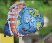  ??  ?? An activist in Pottstown holds up a sign at the Pottstown Climate March Saturday that reads, “We can’t ignore climate change.” The sign was one among a sea of others that expressed concerns over the current administra­tion’s views on environmen­tal policy.