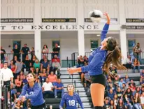  ?? PHOTOS BY GABRIELA CAMPOS/THE NEW MEXICAN ?? St. Michael’s junior outside hitter Miquela Martinez takes a swing during an Aug. 24 match at Capital. Martinez moved from the setter position to an outside hitter spot, even though she was a two-time Class 4A All-State player at her previous position.