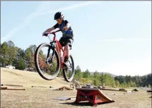  ?? The Sentinel-Record/Beth Reed ?? GETTING AIR: Graelan Rodgers, 12, of Hot Springs, makes a jump on a temporary pump track set up at Cedar Glades Park Saturday in celebratio­n of the Northwoods Trail System grand opening. The track allowed riders of all skill levels to practice or warm up ahead of taking to the new trail system.