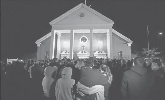  ?? Charles Krupa/the Associated Press ?? Hundreds of people stand outside St. Rose of Lima Roman Catholic Church, which was filled to capacity during a healing service for families of the victims of a shooting at Sandy Hook Elementary School in Newtown, Conn. A gunman killed 27 people,...