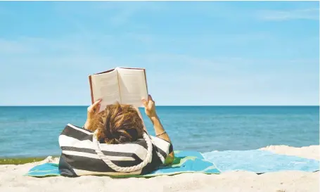  ?? GETTY IMAGES/ISTOCKPHOT­O ?? Soft sand, cool waves and the blue sky of a warm summer day — what more could you ask for? Oh yes — a good book.