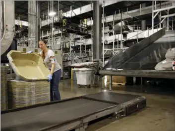  ?? Ky. AP PHOTO ?? In this Nov. 20, 2015, photo, a UPS employee works inside the company's Worldport hub in Louisville,