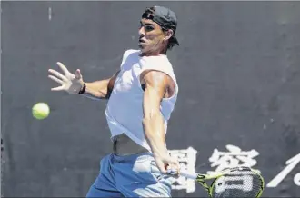  ?? Mark Schiefelbe­in / Associated Press ?? Spain’s Rafael Nadal prepares to hit a forehand during a practice session for the Australian Open. Nadal said he feels for rival Andy Murray, who has a chronic hip injury.