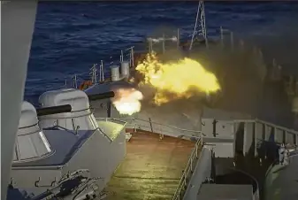  ?? Russian Defense Ministry Press Service ?? A photo from the Russian Defense Ministry shows a cannon blast aboard a warship during a naval exercise in the Black Sea. The U.S. says Moscow is beefing up troops near Ukraine.