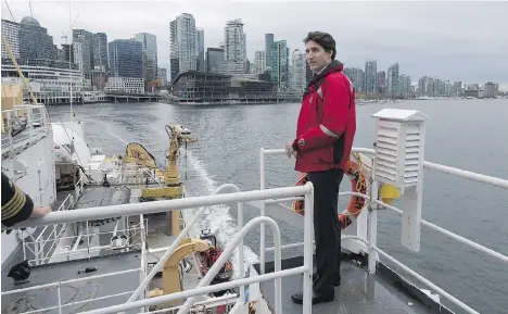  ?? DARRYL DYCK/THE CANADIAN PRESS ?? Prime Minister Justin Trudeau stands on board the Canadian Coast Guard ship Sir Wilfrid Laurier during a tour of the harbour on Monday. Shortly after, Trudeau announced new coastal protection measures, including increased towing capacity on the West...