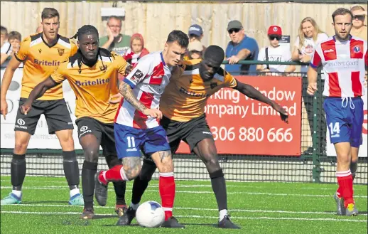  ??  ?? Maidstone’s Clovis Kamdjo and Saidou Khan in the thick of things against Dorking Wanderers on Saturday