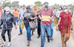  ?? NICHOLAS NUNES ?? Leader of the Opposition and President of the People’s National Party, Mark Golding (second right), leads supporters and colleagues as they demonstrat­e against the higher cost of living at Heroes Circle in Kingston yesterday. Golding submitted a proposal to the Ministry of Finance and the Public Service that the party believes will ease the burden on Jamaicans.