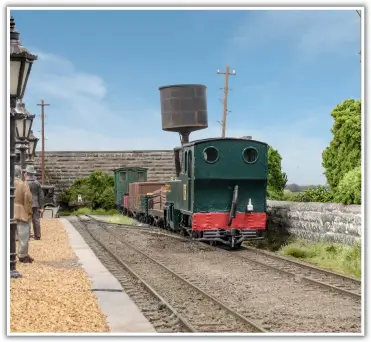  ??  ?? A goods train ready for departure to Leek collects its guard’s van from storage in the spur at the end of the loop.