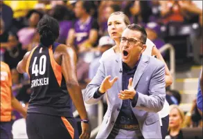  ?? Ringo H.W. Chiu / Associated Press ?? Connecticu­t Sun head coach Curt Miller, right, greets his players during a timeout in the second half of Game 3 of a WNBA playoff game against the Los Angeles Sparks in September.