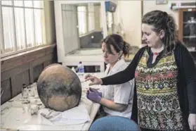  ?? Photo: Stefan Heunis/afp ?? Potted history: Sian Tiley-nel (right), chief curator of the Mapungubwe collection and assistant Helma Steenkamp.
