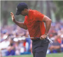  ?? Sam Greenwood / Getty Images ?? Tiger Woods reacts after his long birdie putt on 18 to force a playoff falls short. Woods tied for second.