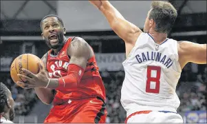  ?? CP PHOTO ?? Toronto Raptors forward C.J. Miles (left) goes towards the basket as Los Angeles Clippers forward Danilo Gallinari tries to guard him during the third quarter of a preseason NBA game Sunday in Honolulu.