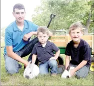  ?? LYNN KUTTER ENTERPRISE-LEADER ?? Cameron Harrison, 15, Hudson Moore, 2, and Kipton Moore, 6, are involved with the family farm. The farm grows soybeans and field corn and the two older boys show pigs and rabbits at the county fair.