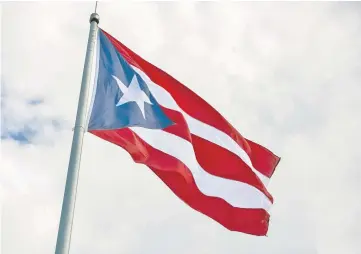  ??  ?? A Puerto Rican flag flies outside the Capitol of Puerto Rico building in San Juan, Puerto Rico, on May 13. — WP-Bloomberg photo