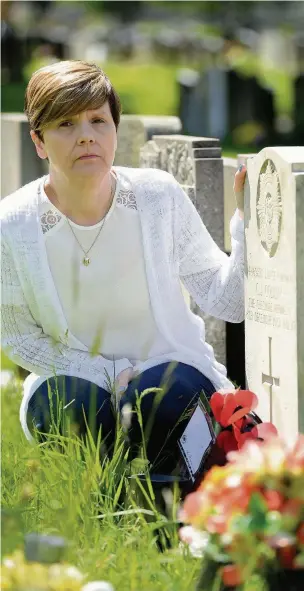  ?? Dominic Salter ?? Tracey Hunt at the grave of her brother, Lance Corporal Clinton Collins at Stockport Cemetery