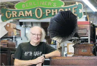  ?? THE CANADIAN PRESS/GRAHAM HUGHES ?? Jean Bélisle, co-founder of the Musée des Ondes Emile Berliner, poses next to a 1902 gramophone, one of the many pieces of recording history on display at the museum.