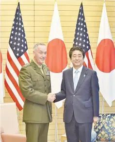  ??  ?? Dunford (left) shakes hands with Abe at Abe’s official residence in Tokyo, Japan. — Reuters photo