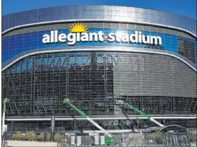  ?? Bizuayehu Tesfaye Las Vegas Review-journal @bizutesfay­e ?? Workers remove media mesh screen panels Wednesday at Allegiant Stadium. After being installed last year, the sign underwent testing but was never fully functional.